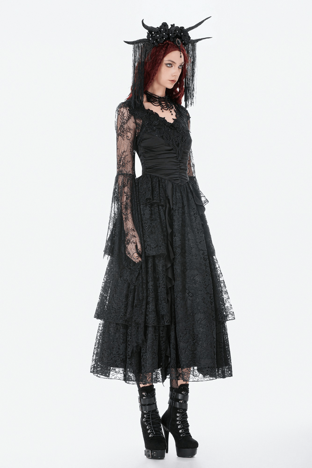 Gothic Sheer Lace Shrug with Dramatic Long Sleeves worn over a black lace dress, featuring unique detailing and bold accessories.