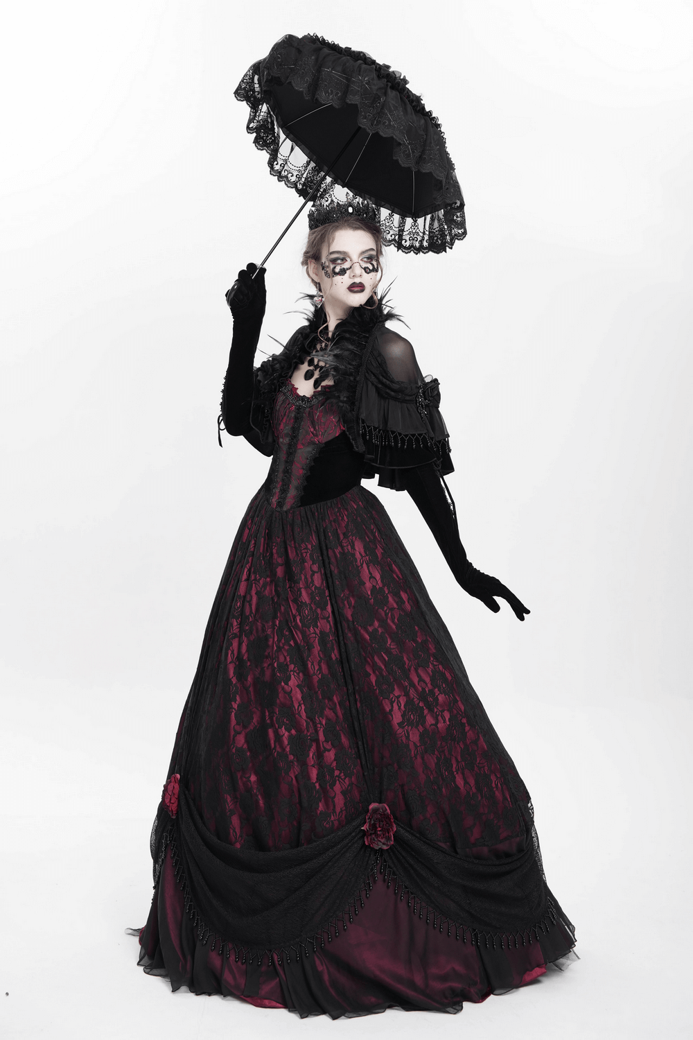 Gothic model in a stunning Victorian-inspired dress with lace, ruffles, and a black parasol for dramatic flair.