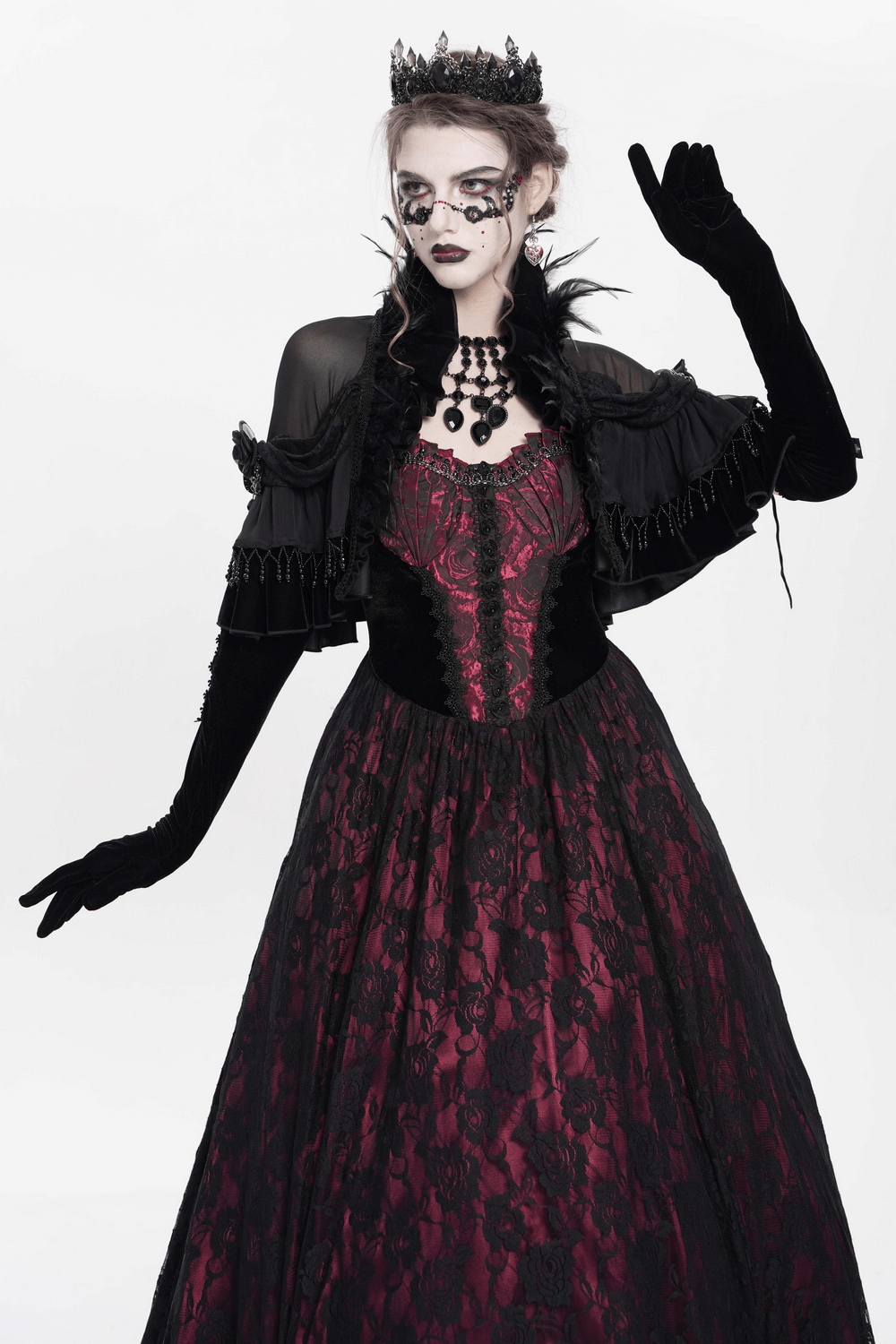 Gothic sheer mesh shrug with ruffles and feather trim over Victorian gown for alternative fashion and cosplay.