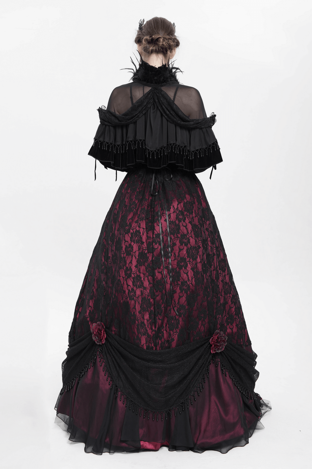 Gothic sheer mesh shrug with ruffles over Victorian-inspired lace gown, featuring dramatic feather trim and elegant beads.