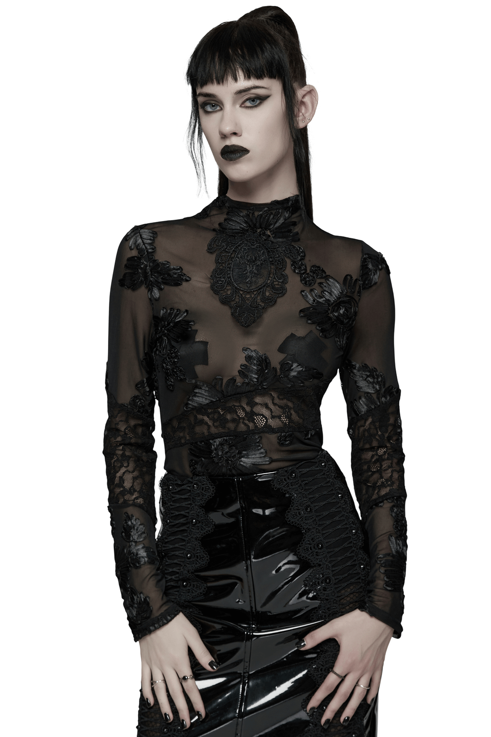 Gothic Sheer Mesh Top with 3D Floral Lace Detail styled with a glossy black skirt.