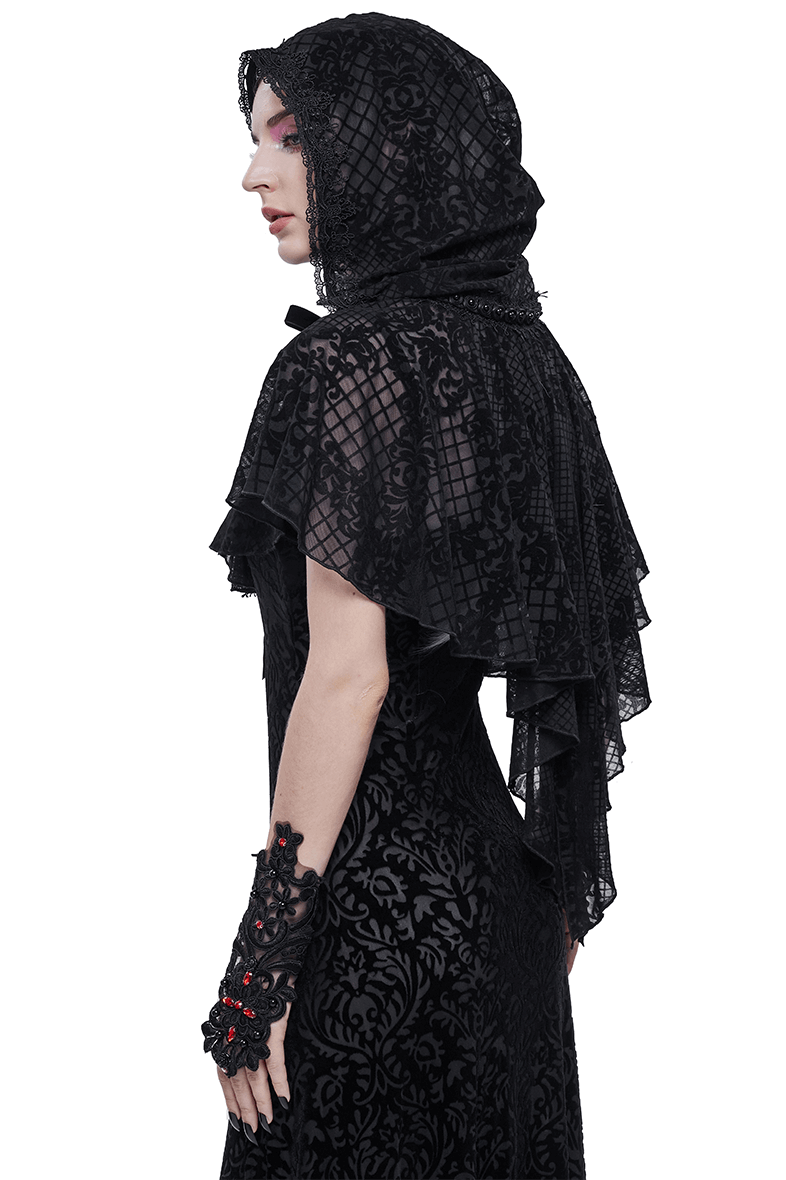 Side view of a woman in a gothic black hooded cape, showcasing intricate floral patterns and elegant detailing.