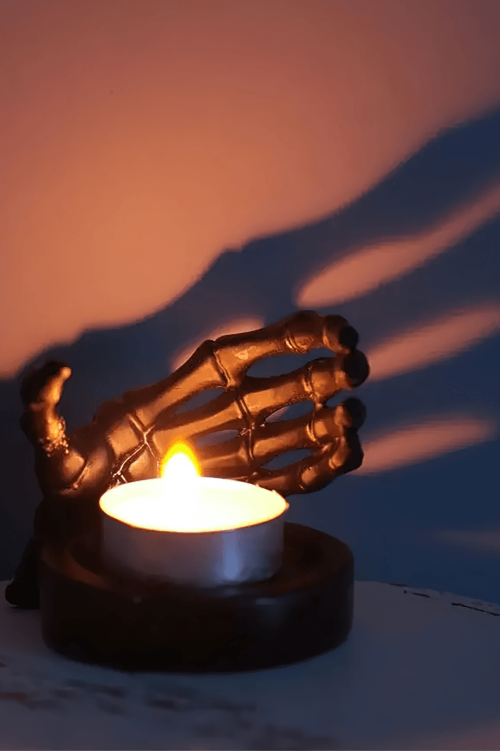 Gothic Skeletal Hand Candle Holder for Dark Decor showcasing a lit candle in a spooky bone hand holder.
