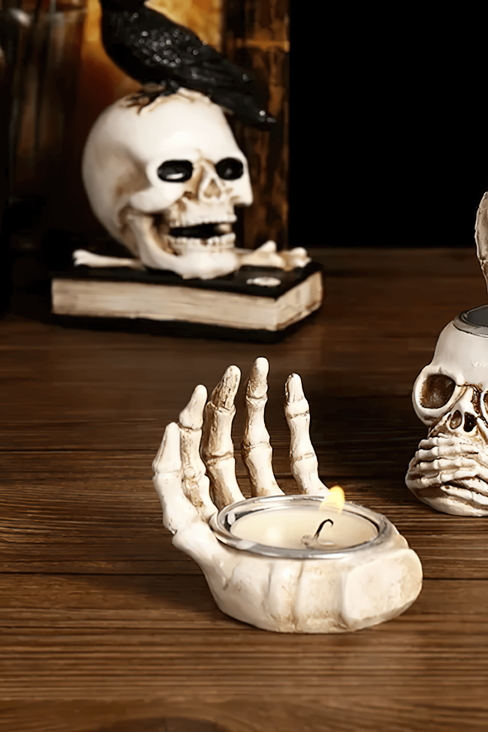 Gothic skeleton hand candle holder for Halloween decor with a tea light candle, perfect spooky centerpiece.