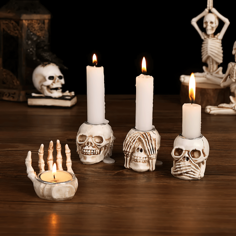 Gothic skeleton hand candle holder with lit tea lights, perfect for Halloween and spooky decor.