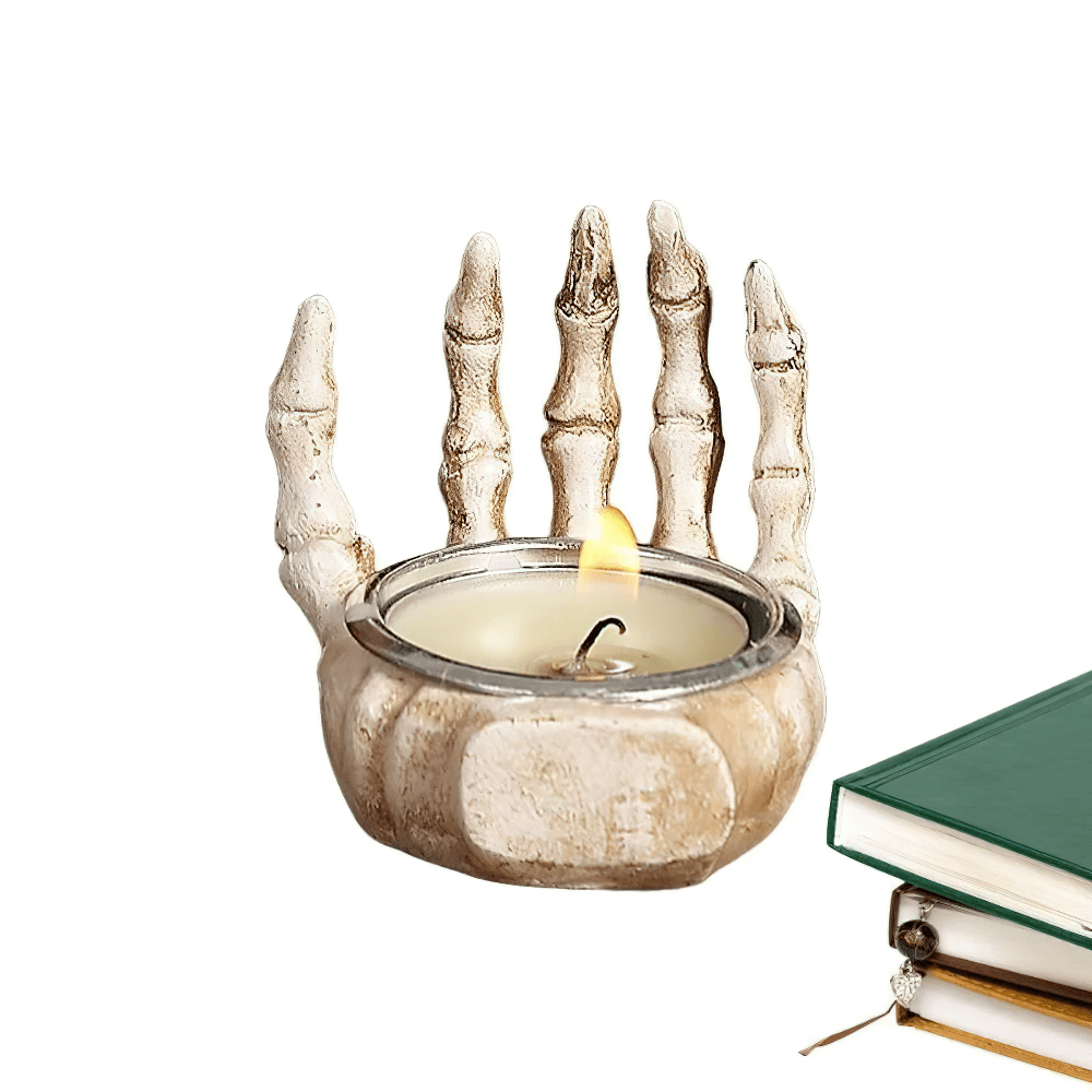 Gothic skeleton hand candle holder with a lit tea light, perfect for Halloween decor and spooky gifts.