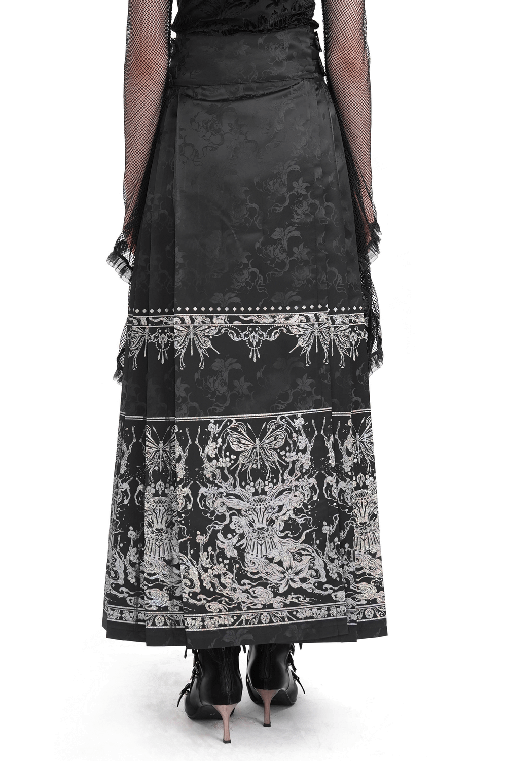 Back view of a flowing black gothic skirt with intricate silver embroidery and embellishments.