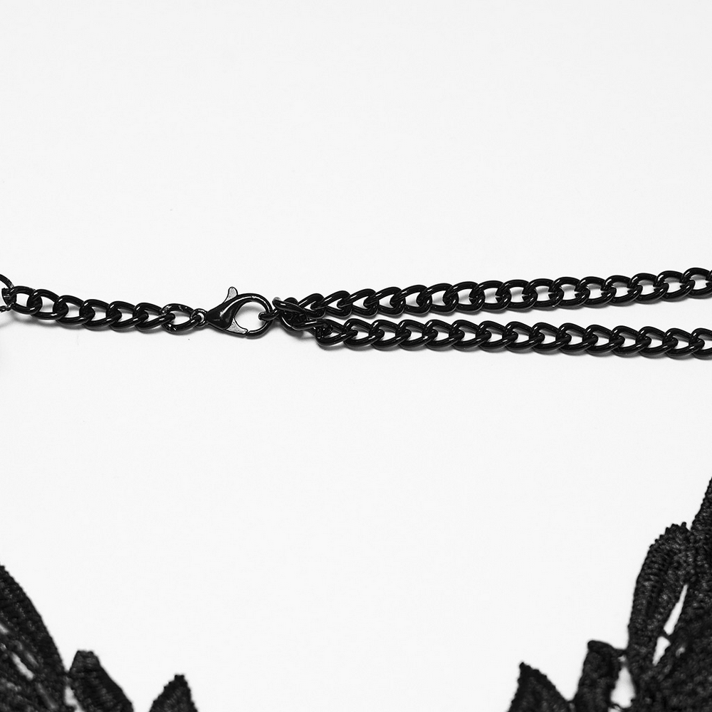 Close-up of the clasp on the Gothic Skull Chain Body Harness with Lace Details showcasing aged metal chains and lace.