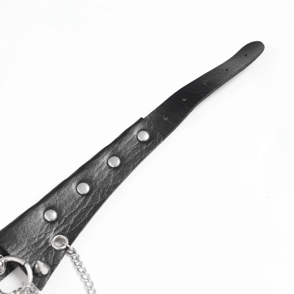 Close-up of gothic skull choker's black faux leather strap with silver studs and chain detail.