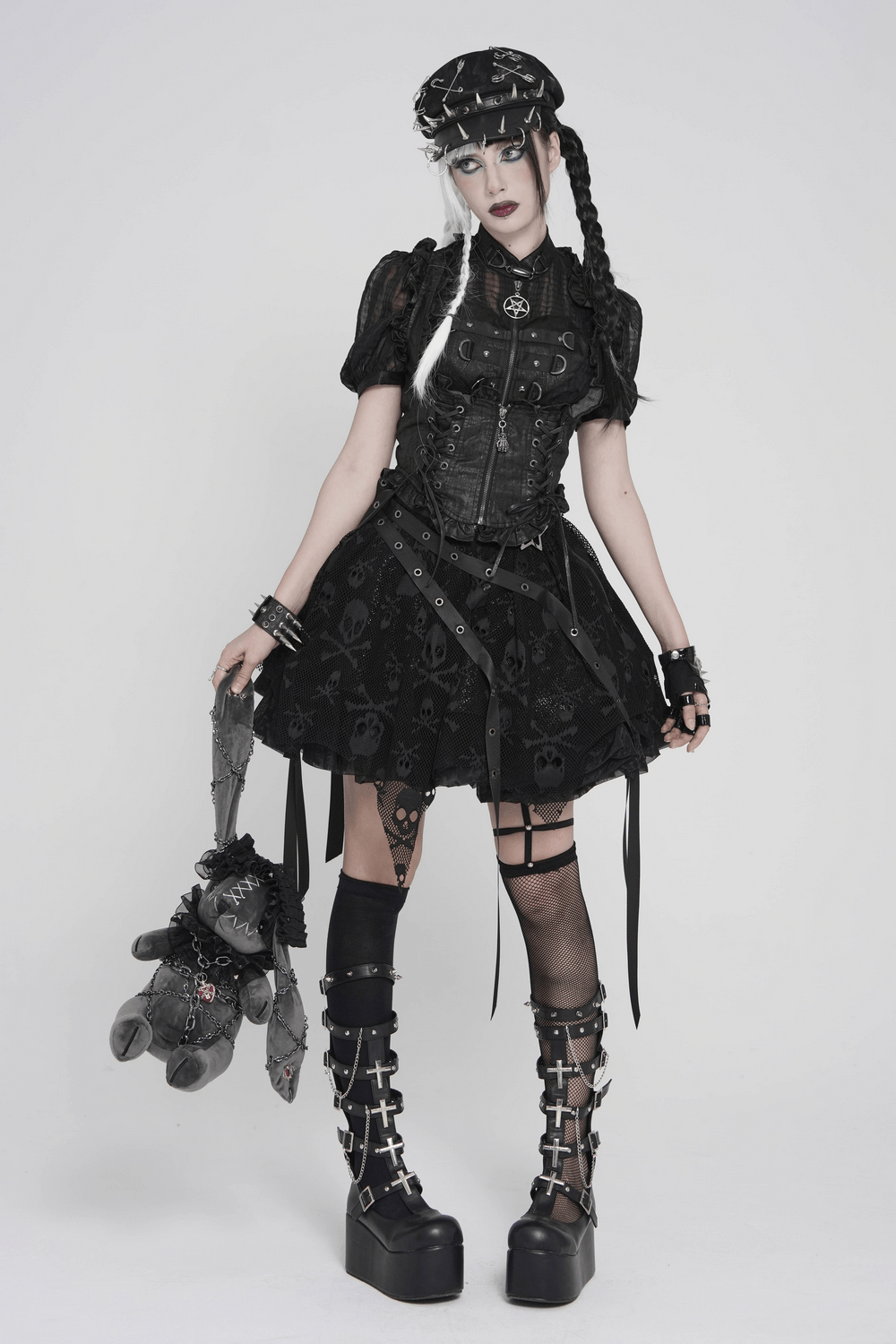 Gothic Skull Lace Mini Skirt with Strap Details worn by a model, showcasing a punk style with accessories and platform boots.