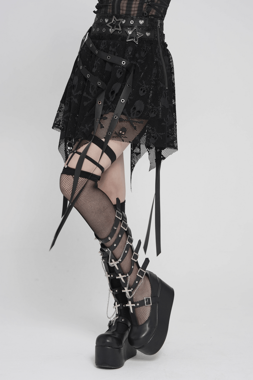 Gothic Skull Lace Mini Skirt with Strap Details showcasing a punk look with star buckles and fishnet tights.