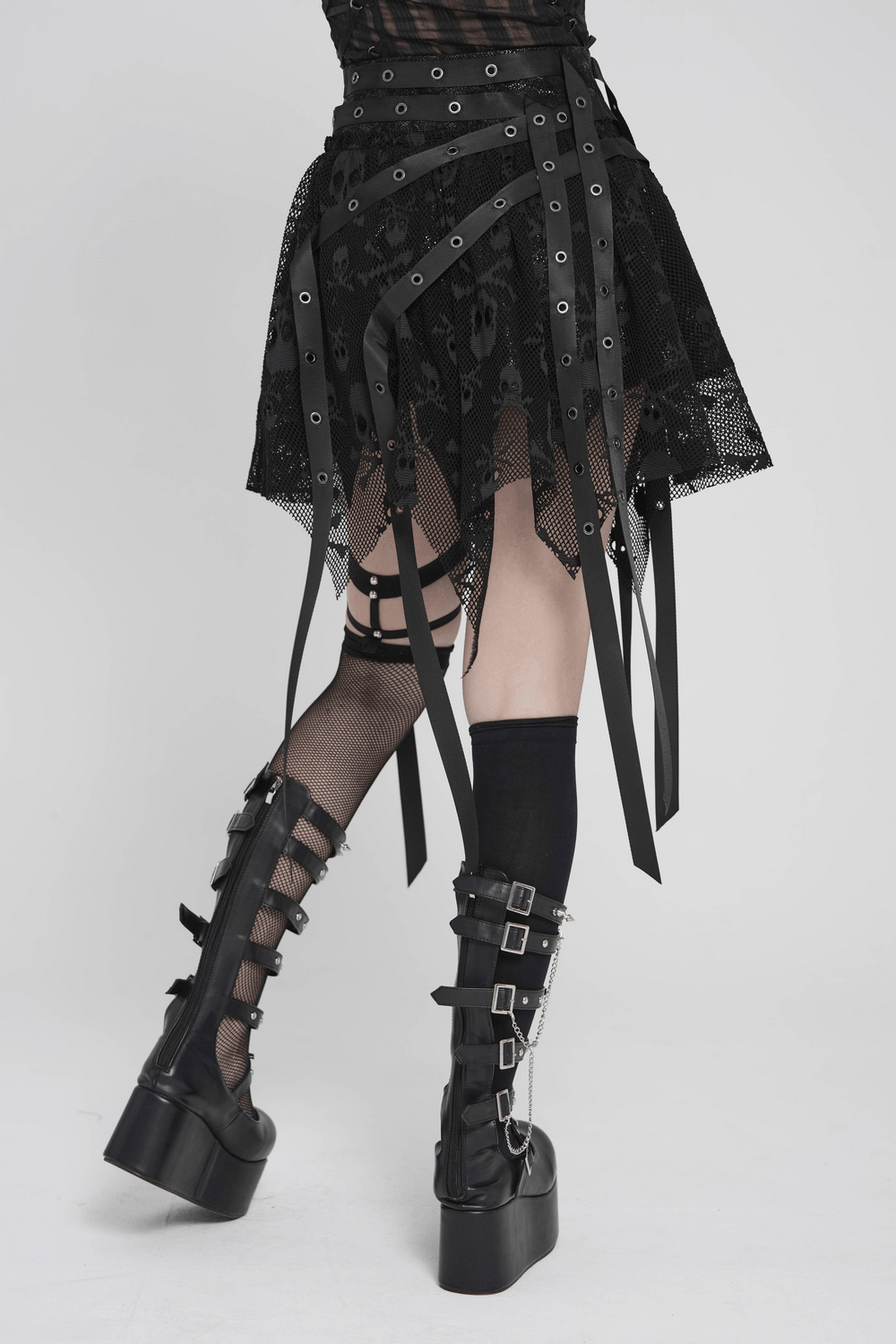 Gothic Skull Lace Mini Skirt with Strap Details showing sheer layers and punk-style strap accents.