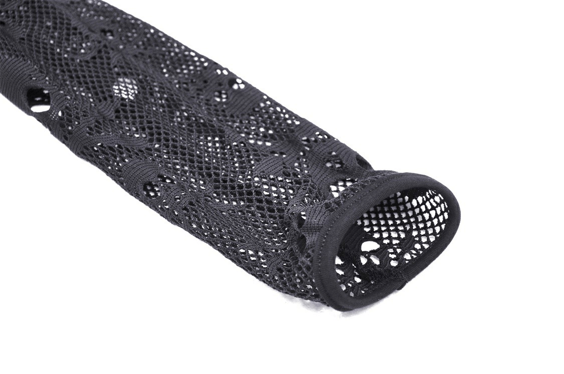 Close-up of black fishnet fabric showcasing intricate skull design for edgy apparel.