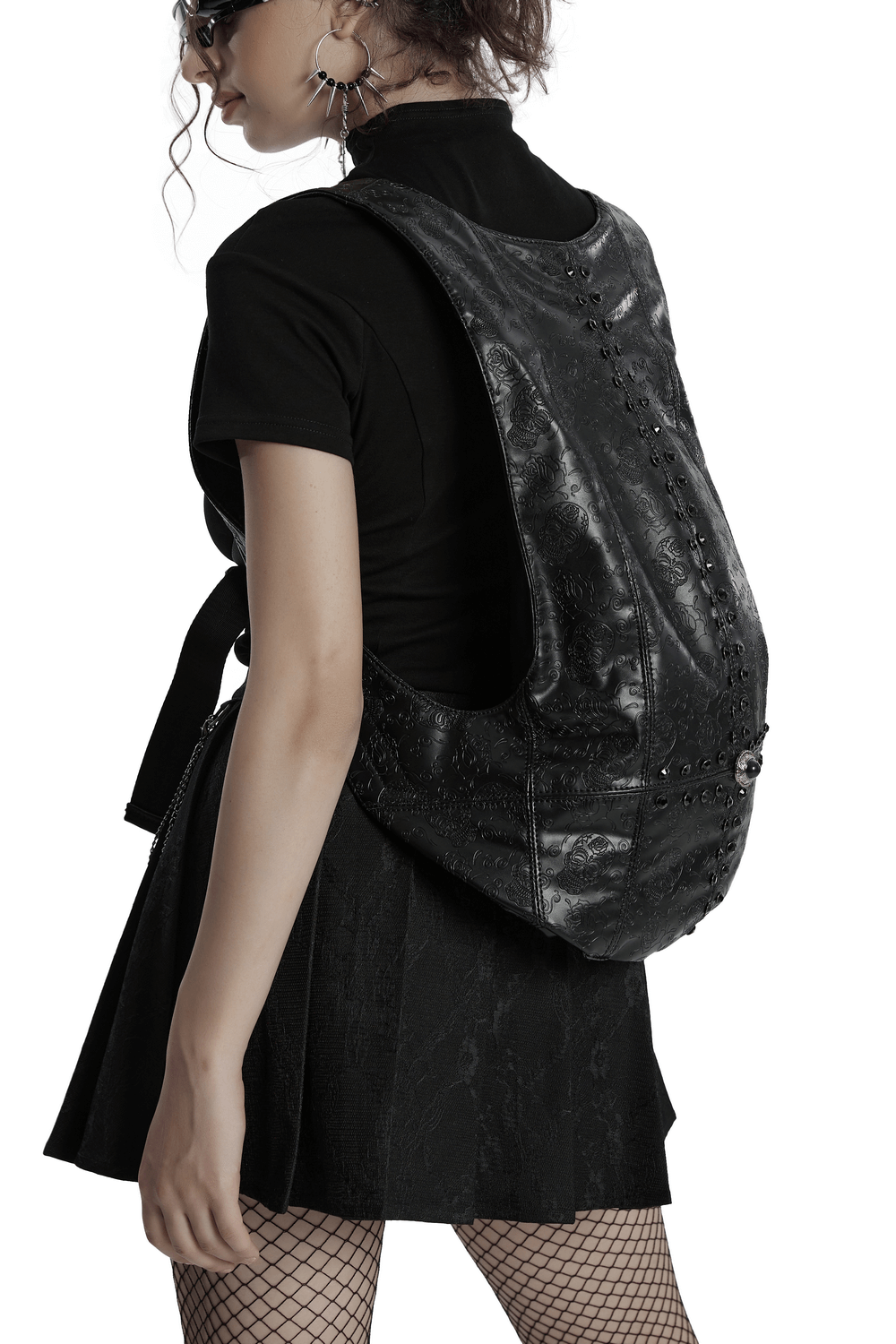 Gothic skull pattern faux leather backpack with buckle, perfect for edgy style and functionality, worn by stylish model.