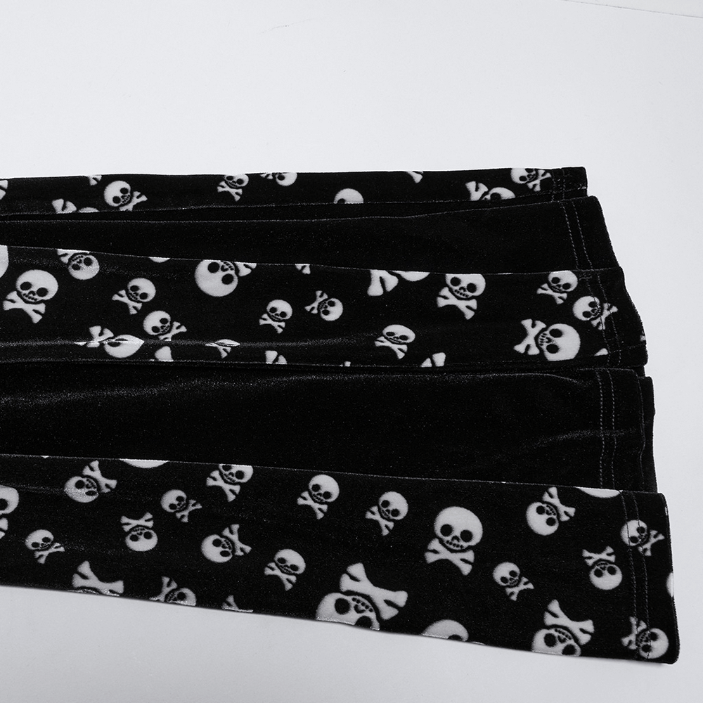 Gothic skull print fabric featuring white skulls on a black background, perfect for alternative fashion designs.