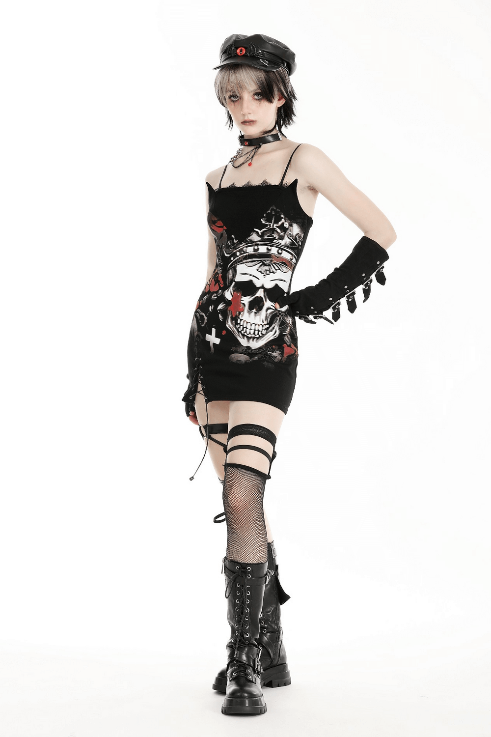 Gothic skull print sleeveless mini dress with lace detail, paired with edgy accessories and stylish boots.