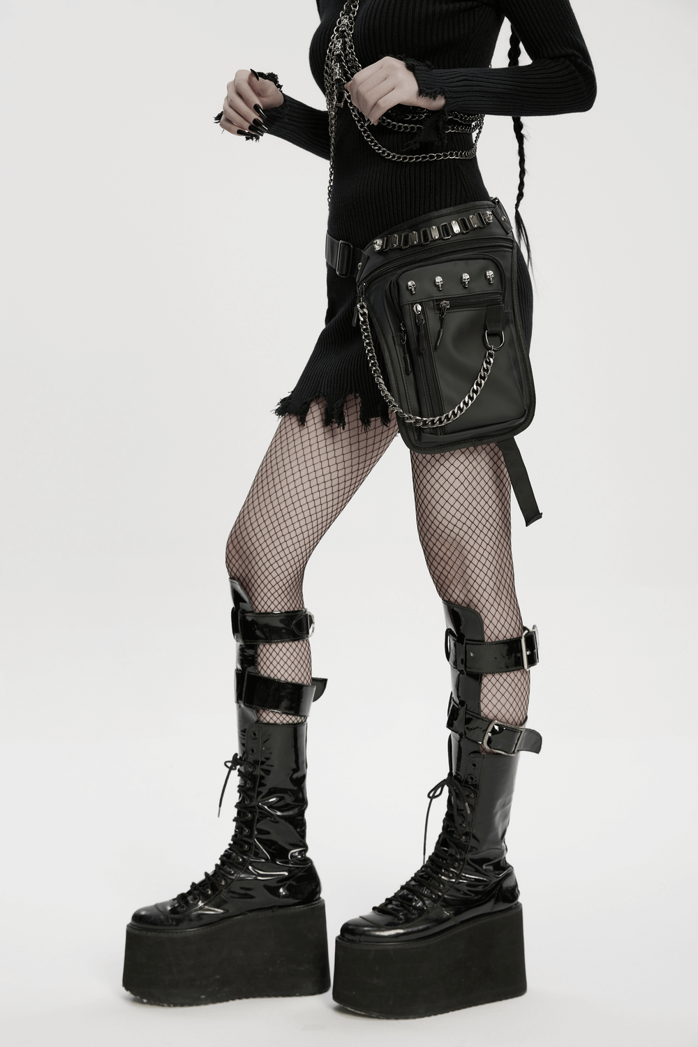 Gothic skull waist and leg bag with chains, pockets, and stylish fishnet leggings, perfect for edgy fashion lovers.