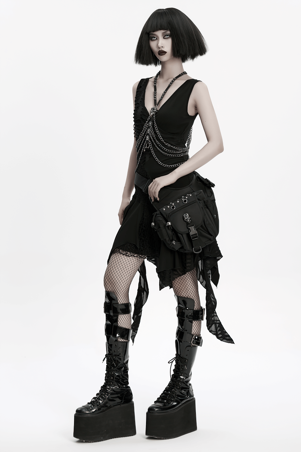 Gothic model wearing a black dress with chains, fishnet stockings, and a punk waist-leg bag with rivets.