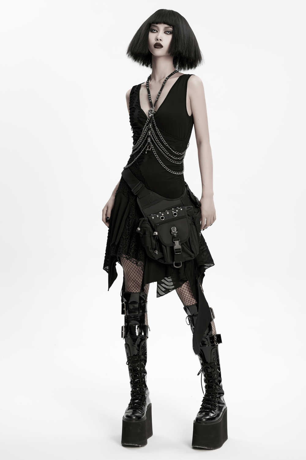 Gothic skull waist and leg bag with rivet detailing worn by model in punk-inspired outfit.