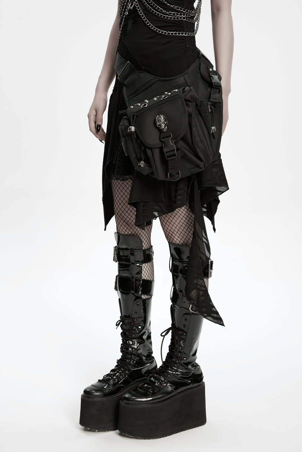 Gothic skull waist-leg bag with rivet details worn by a model in punk fashion, featuring striking platform boots.