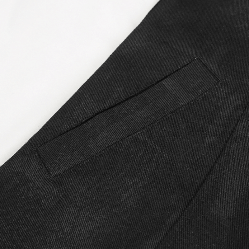 Close-up of gothic asymmetric coat fabric, showcasing pocket detail and black texture.