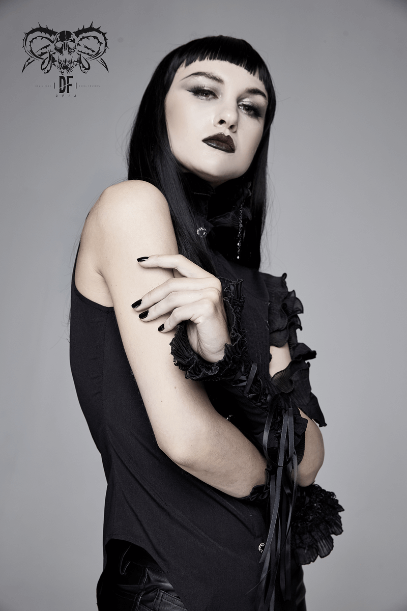 Gothic sleeveless black blouse with floral embroidery and wavy ruffles on model, showcasing unique style and design.