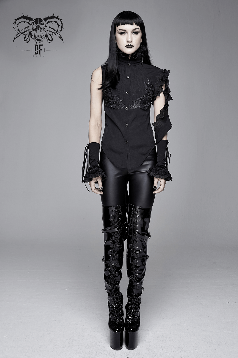 Gothic sleeveless black blouse with floral embroidery and wavy ruffles, styled for a unique fashion statement.