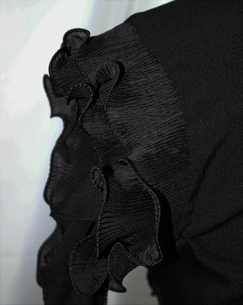 Close-up of the ruffled edge on a gothic black blouse sleeve, showcasing intricate design and texture.