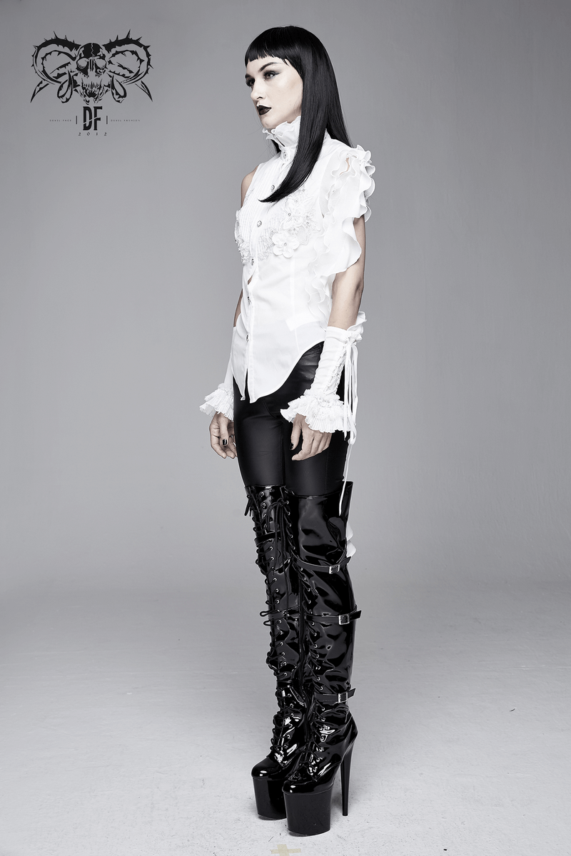 Gothic sleeveless blouse with wavy ruffles and floral embroidery, paired with stylish black leggings and platform boots.