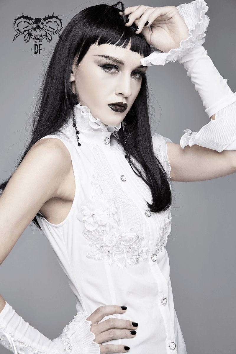 Gothic sleeveless blouse with wavy ruffles and floral embroidery, model showcasing a stylish white shirt.