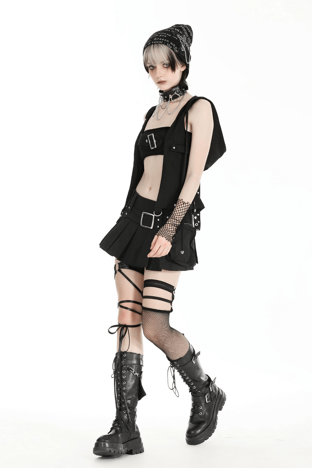 Gothic sleeveless hooded top with buckle straps, styled with layered punk accessories and combat boots.