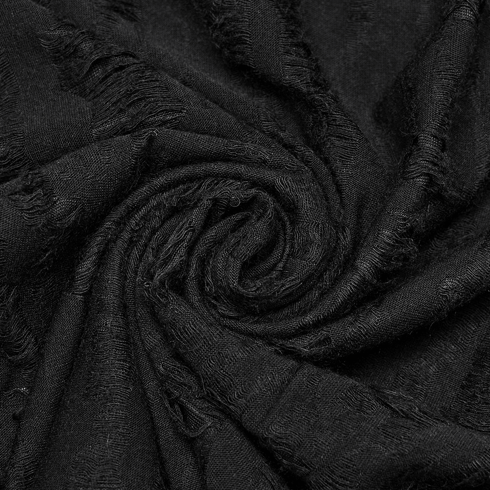 Close-up of tattered black knitted fabric showcasing distressed texture for punk fashion.
