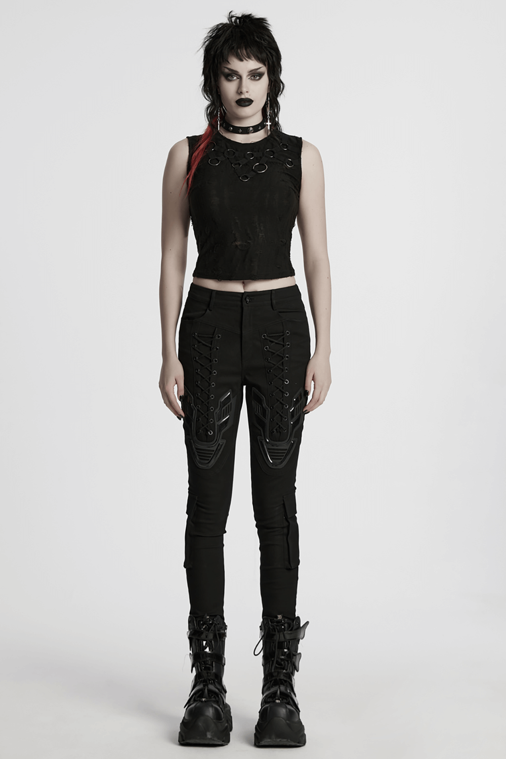 Gothic sleeveless top with iron rings, paired with edgy black pants for a punk-inspired, avant-garde outfit.