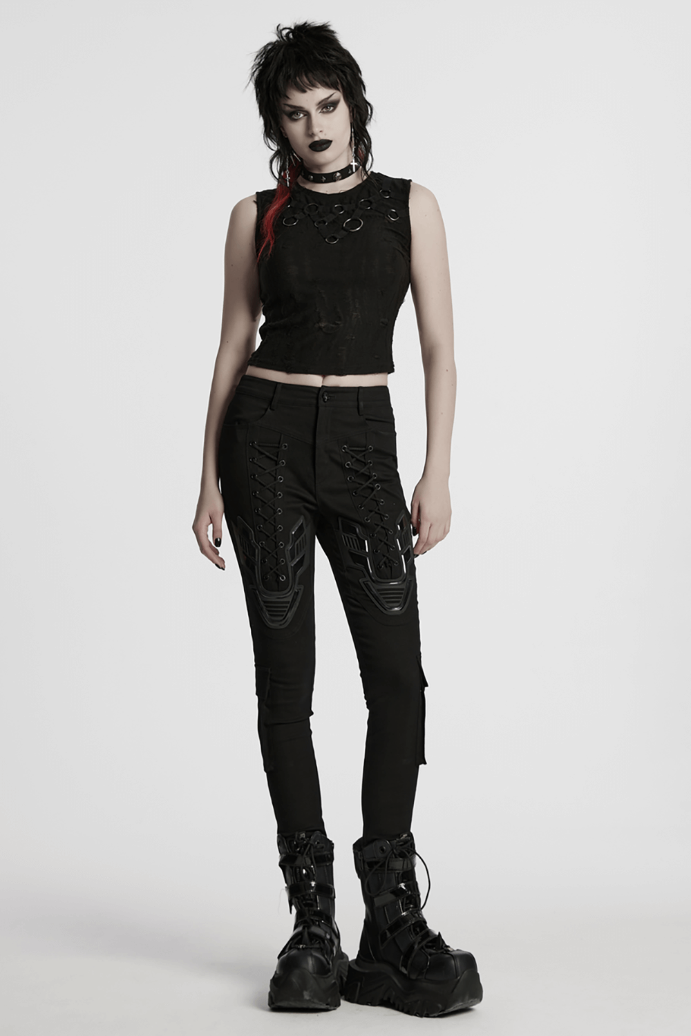 Gothic sleeveless top with iron rings, paired with edgy black pants for a punk streetwear look.
