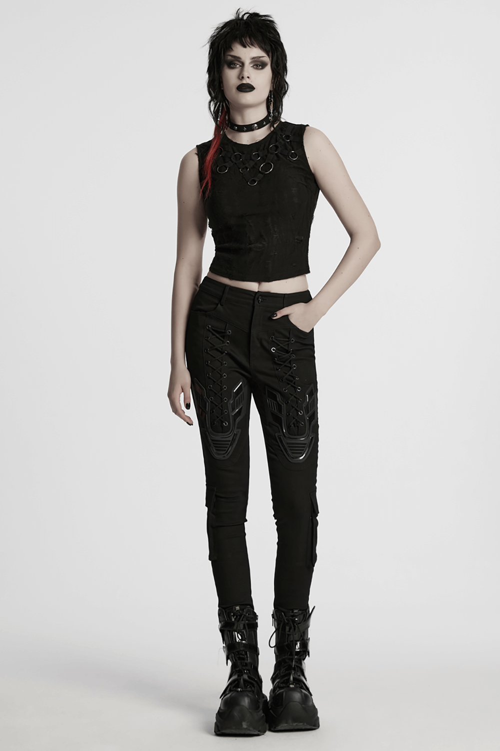 Gothic sleeveless top with iron rings, paired with edgy black pants for a punk streetwear vibe.