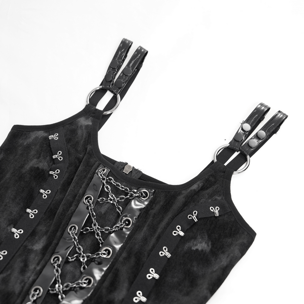 Gothic slip dress detail with black velvet fabric, silver chains, and lace-up straps for a dark, edgy style.