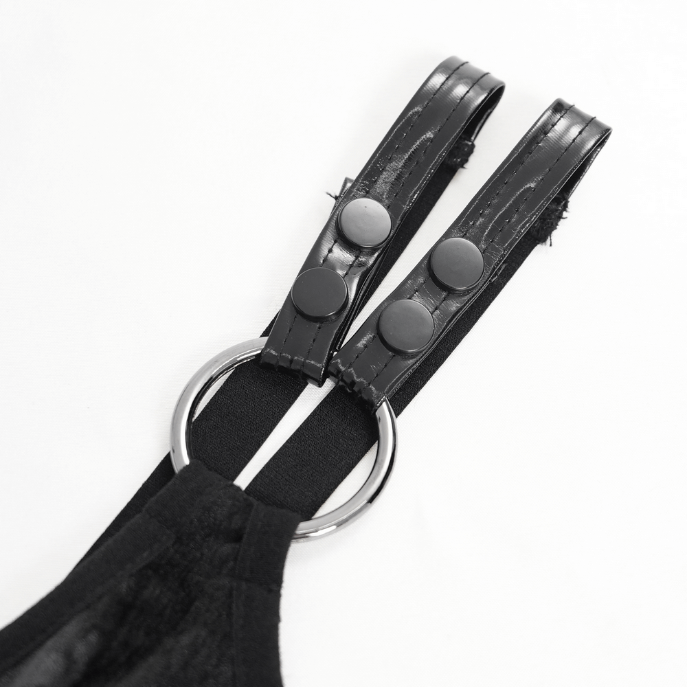 Close-up of gothic slip dress straps featuring black buttons and a circular ring for a stylish, edgy look.