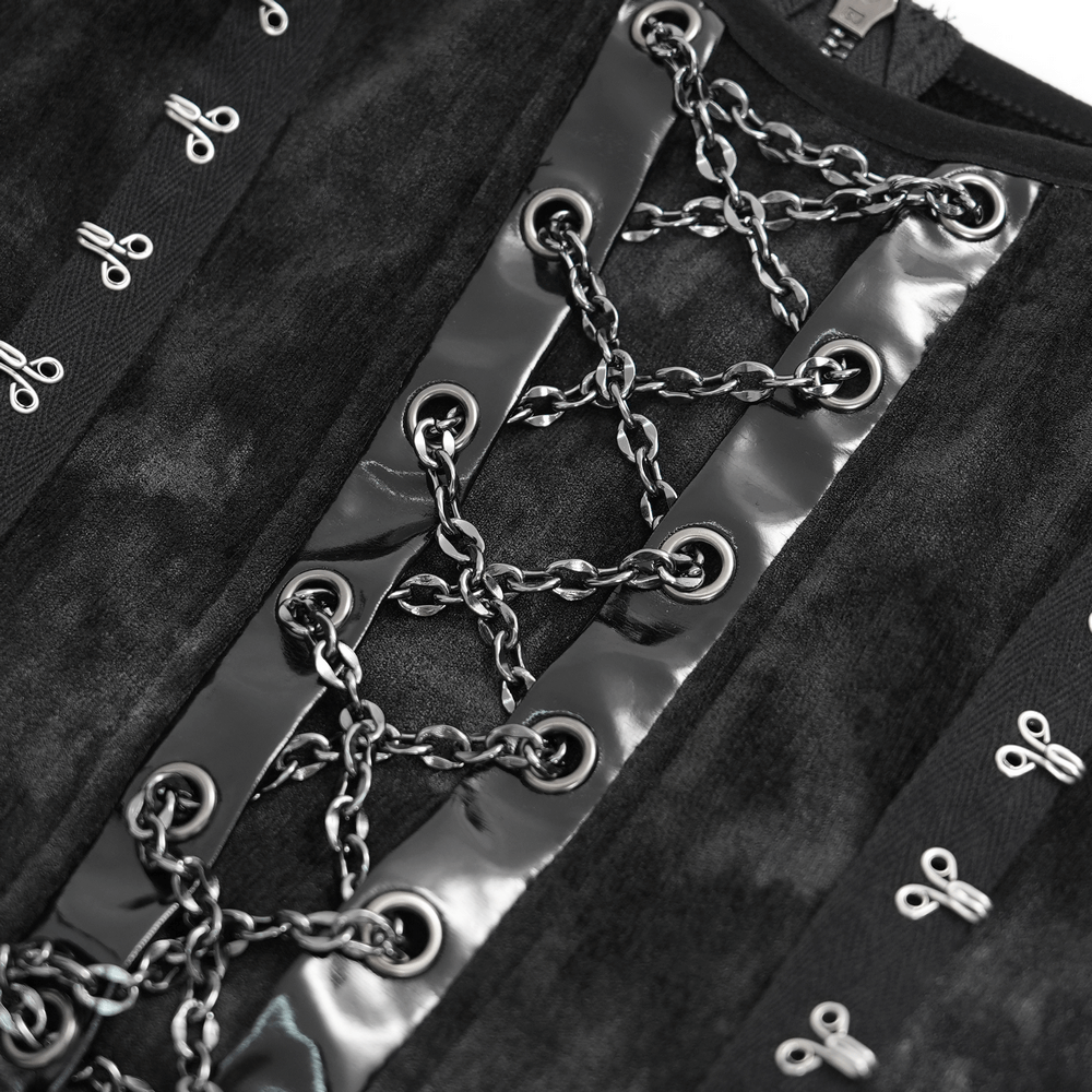 Close-up of gothic slip dress featuring black velvet fabric, shiny chains, and intricate lace-up details.