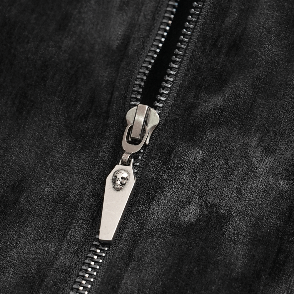 Close-up of a gothic zip with skull-shaped pull on a black fabric, perfect for edgy fashion lovers.