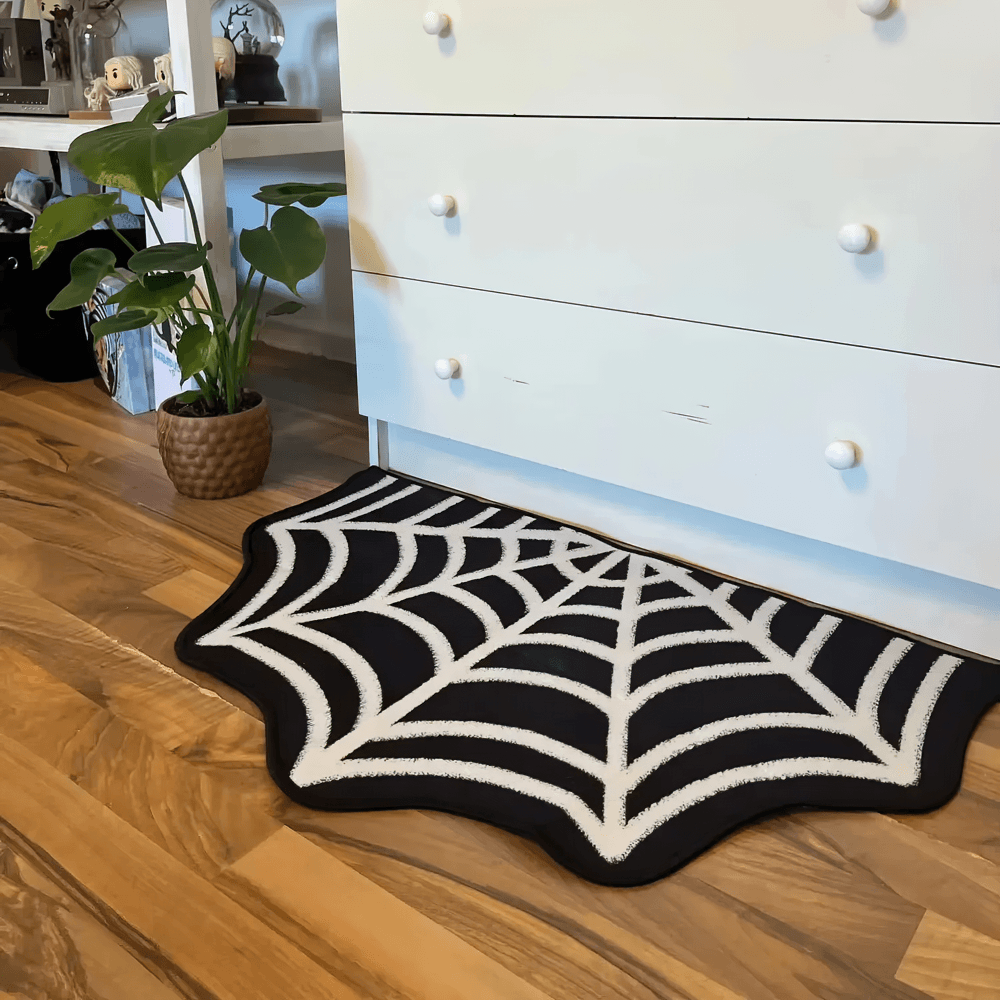 Gothic Spider Web Halloween Rug for Gothic Decor placed on wooden floor beside a potted plant.