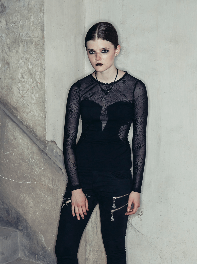 Gothic spider web long sleeve lace top worn by model against a textured wall, showcasing its trendy black design.