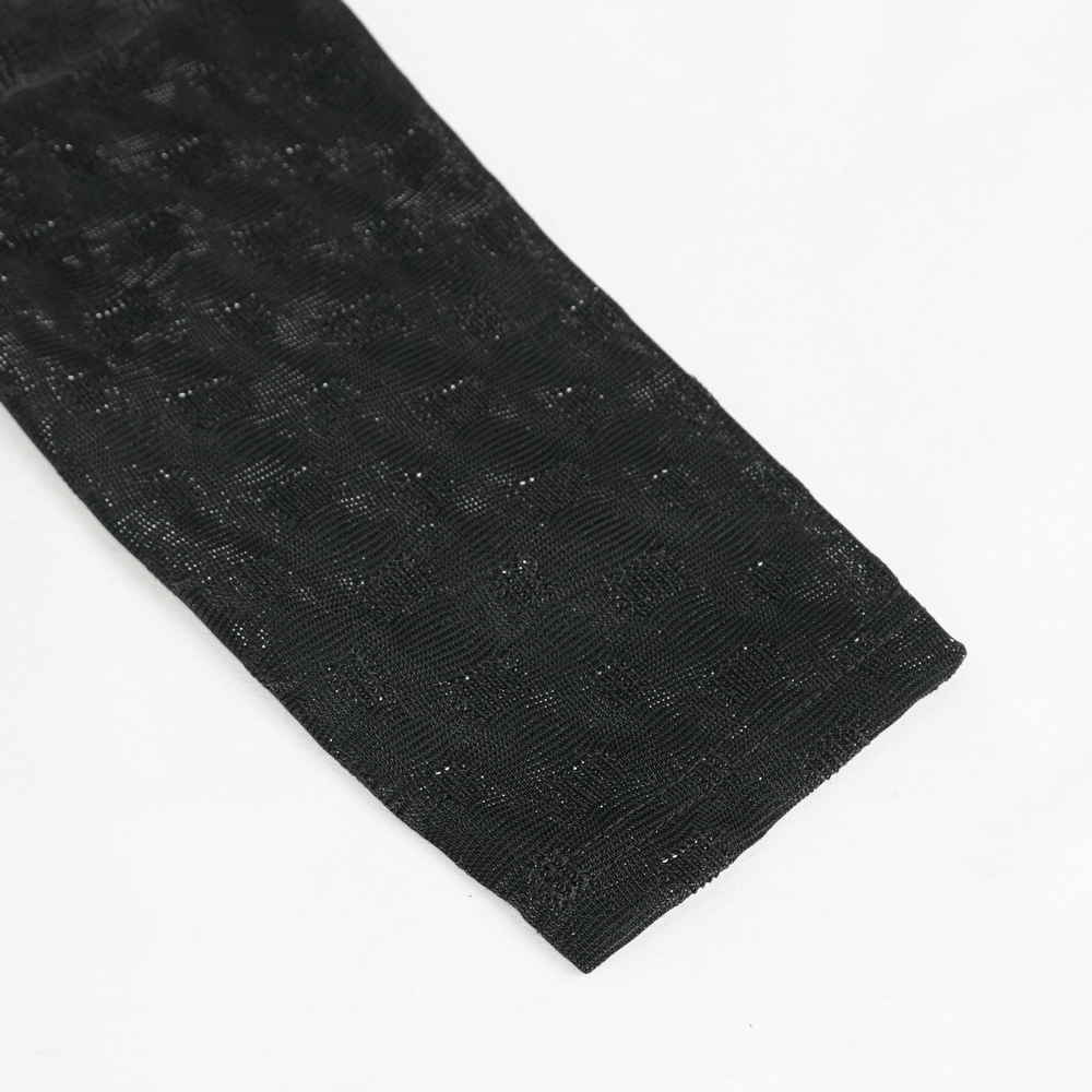 Close-up of the textured black fabric sleeve of a women's gothic long sleeve top.