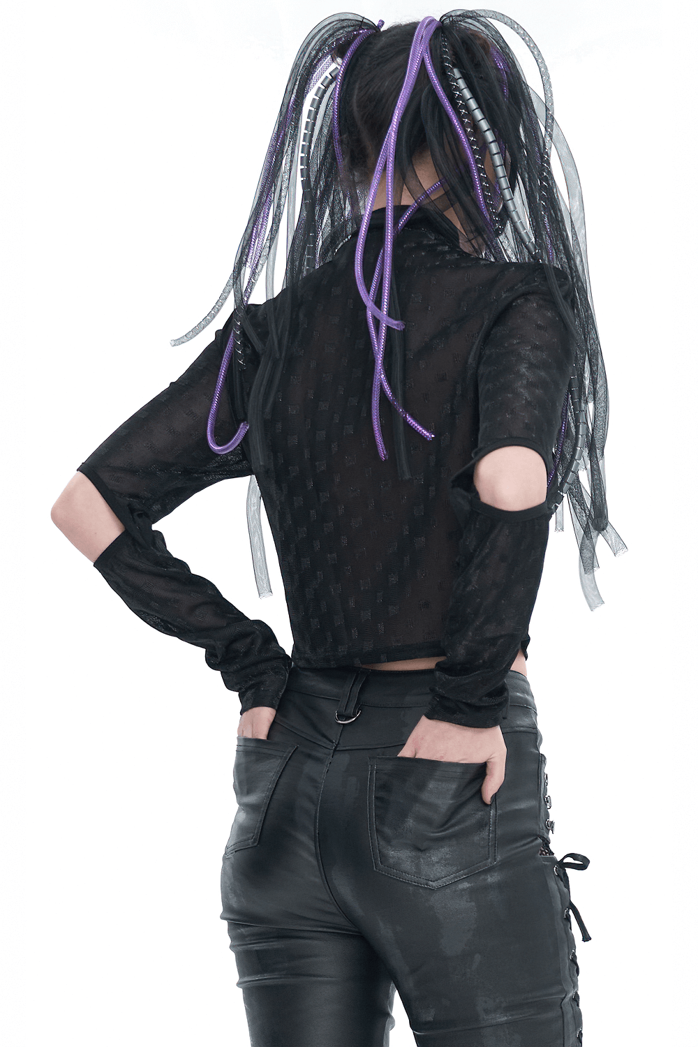 Back view of a woman in a black gothic long sleeve top with split sleeves and purple hair accents.