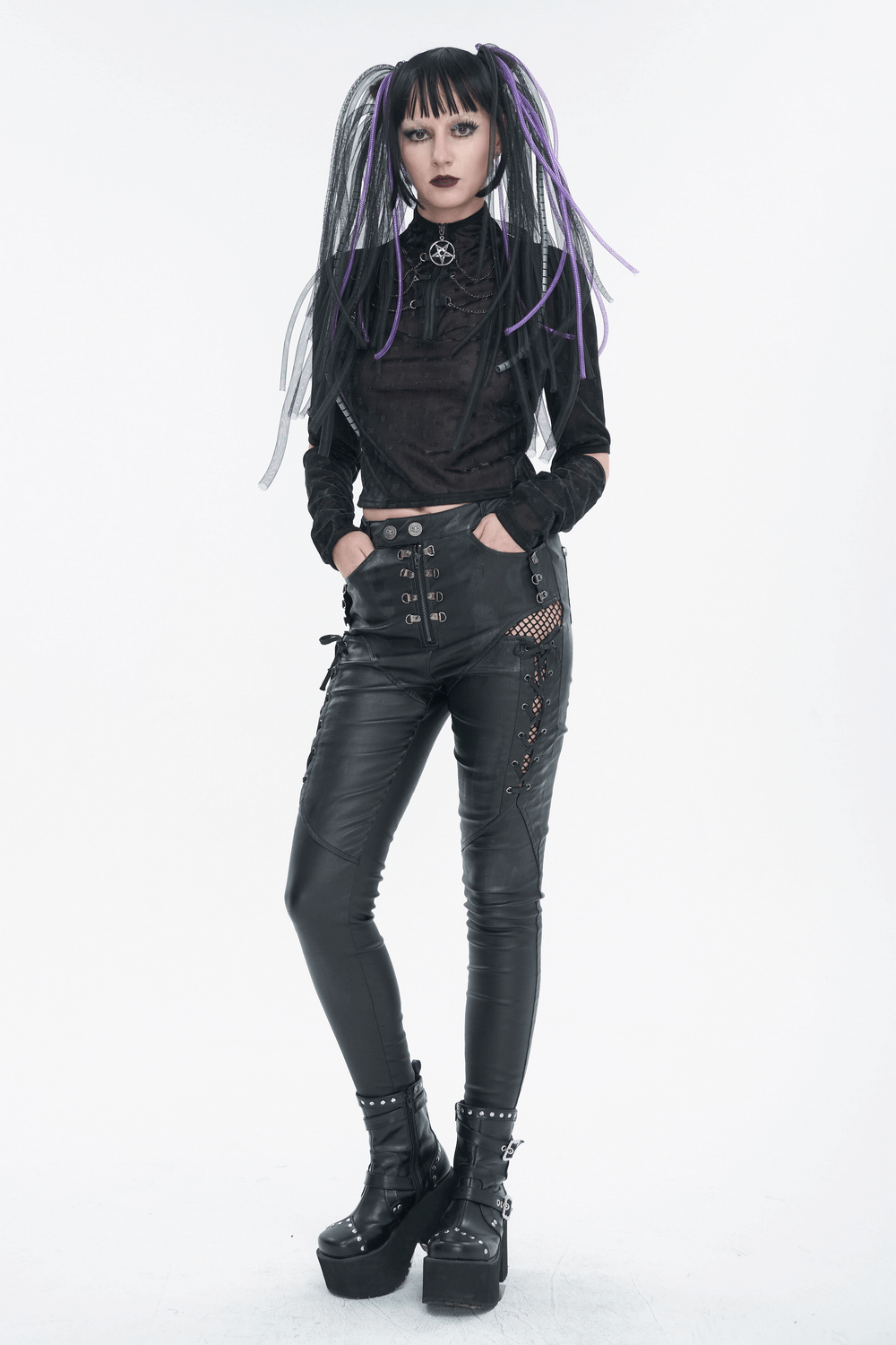 Gothic woman in black pentagram zipper top and leather pants, showcasing trendy gothic fashion style with unique hair.