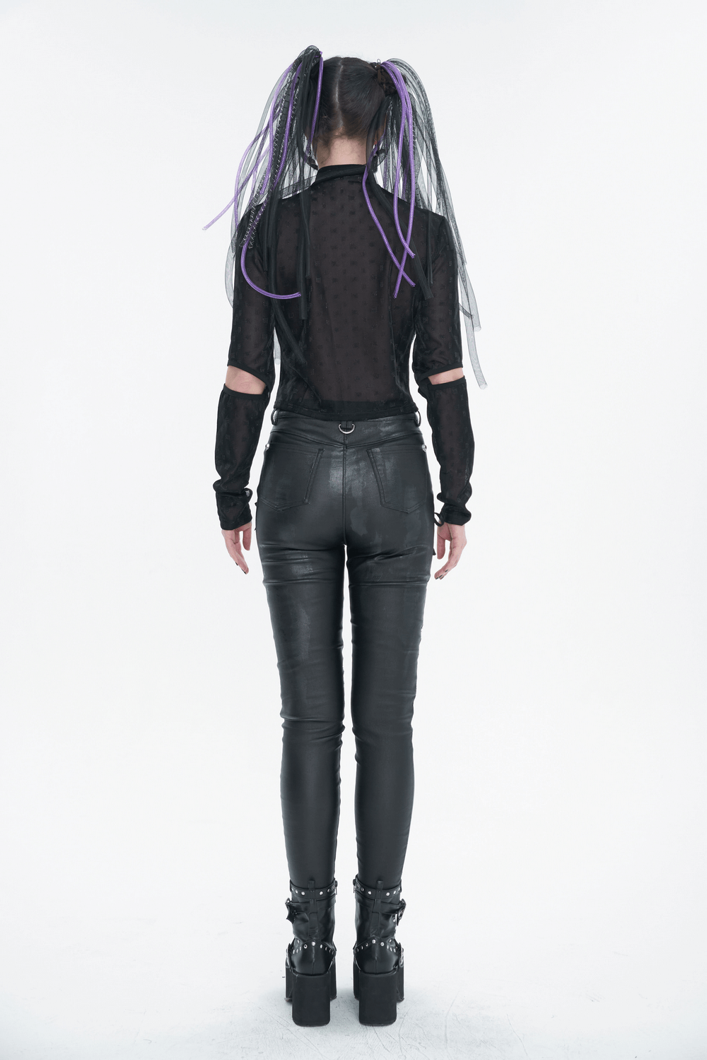 Back view of a woman in a gothic long sleeve black top and faux leather pants, showcasing edgy fashion style.