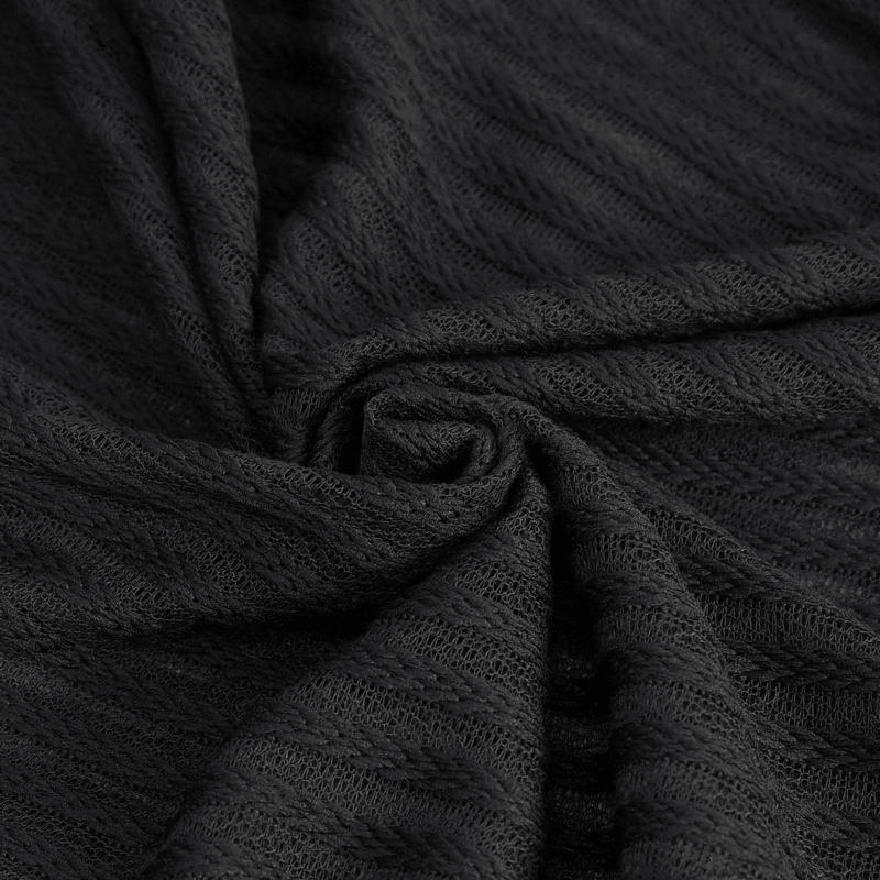 Close-up of black textured fabric, showcasing intricate patterns perfect for gothic fashion.