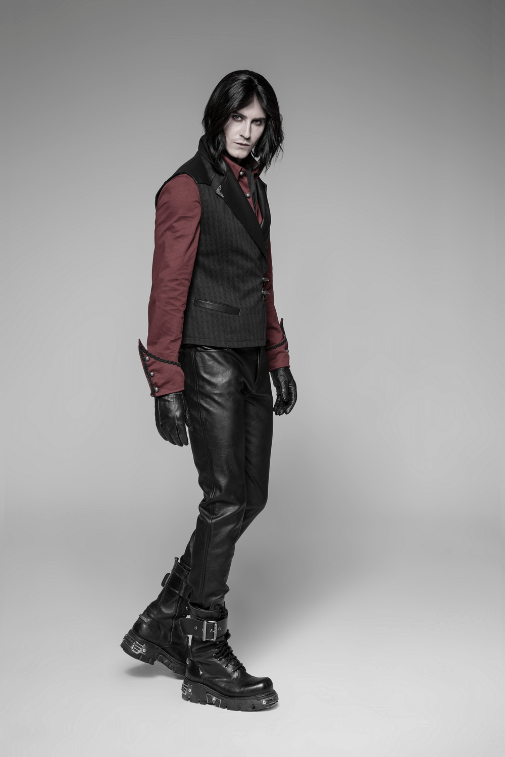 Man in Gothic Striped PU Leather Buckle Waistcoat with stylish black leather pants and edgy boots.