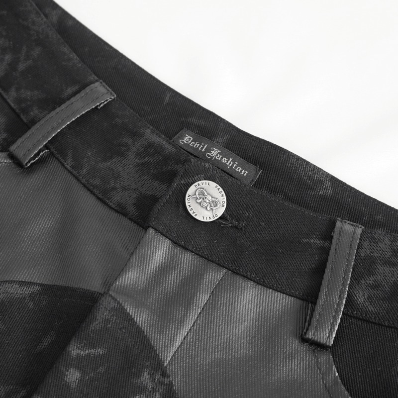 Close-up of Devil Fashion label on black gothic trousers showcasing stylish buckle and fabric details.