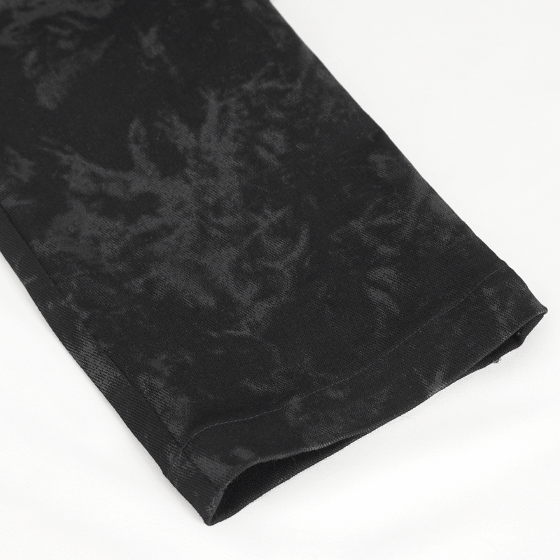 Close-up of the hem detail on men's gothic black buckled trousers with a textured fabric.