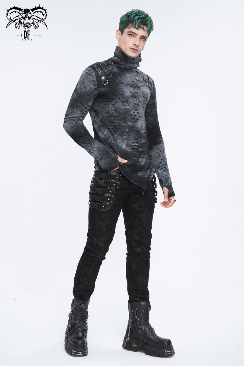 Stylish male model showcasing gothic black buckled trousers and high-fashion top with edgy details.